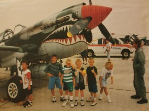 Wes Alberts (in green), with the P-51 Mustang that helped spark his interest in flying.