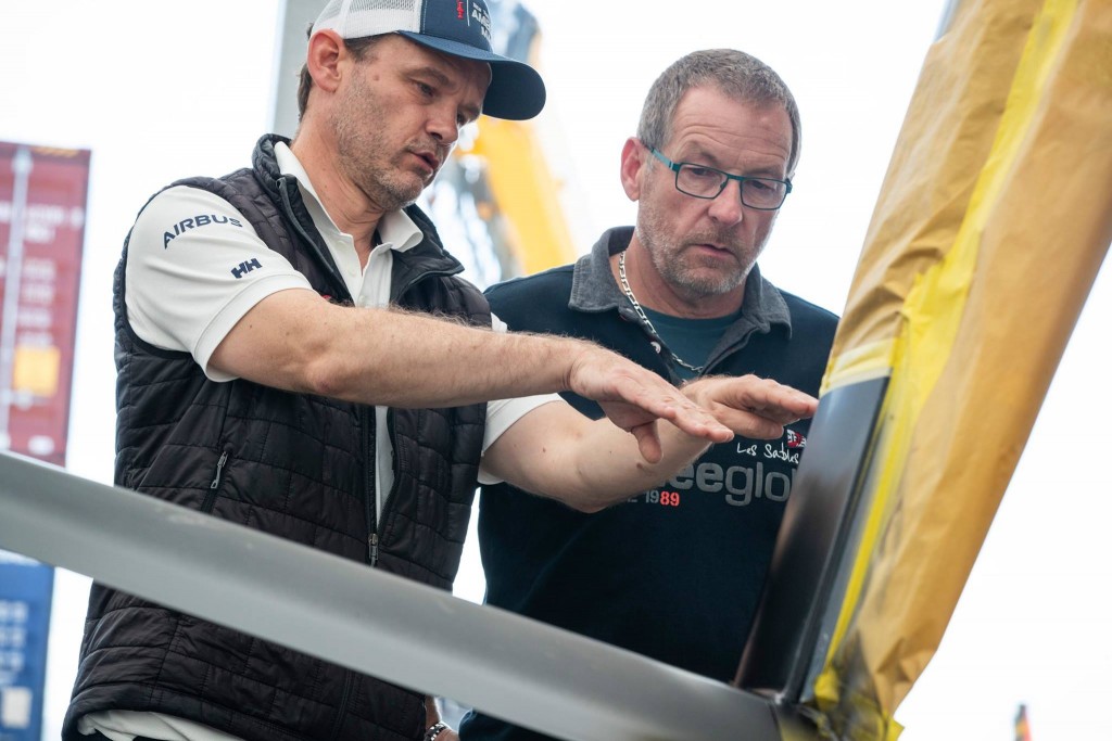 Yves Le-Biannic (left) shows Laurent Blattner (right) how wing technology is integrated into the boat.
